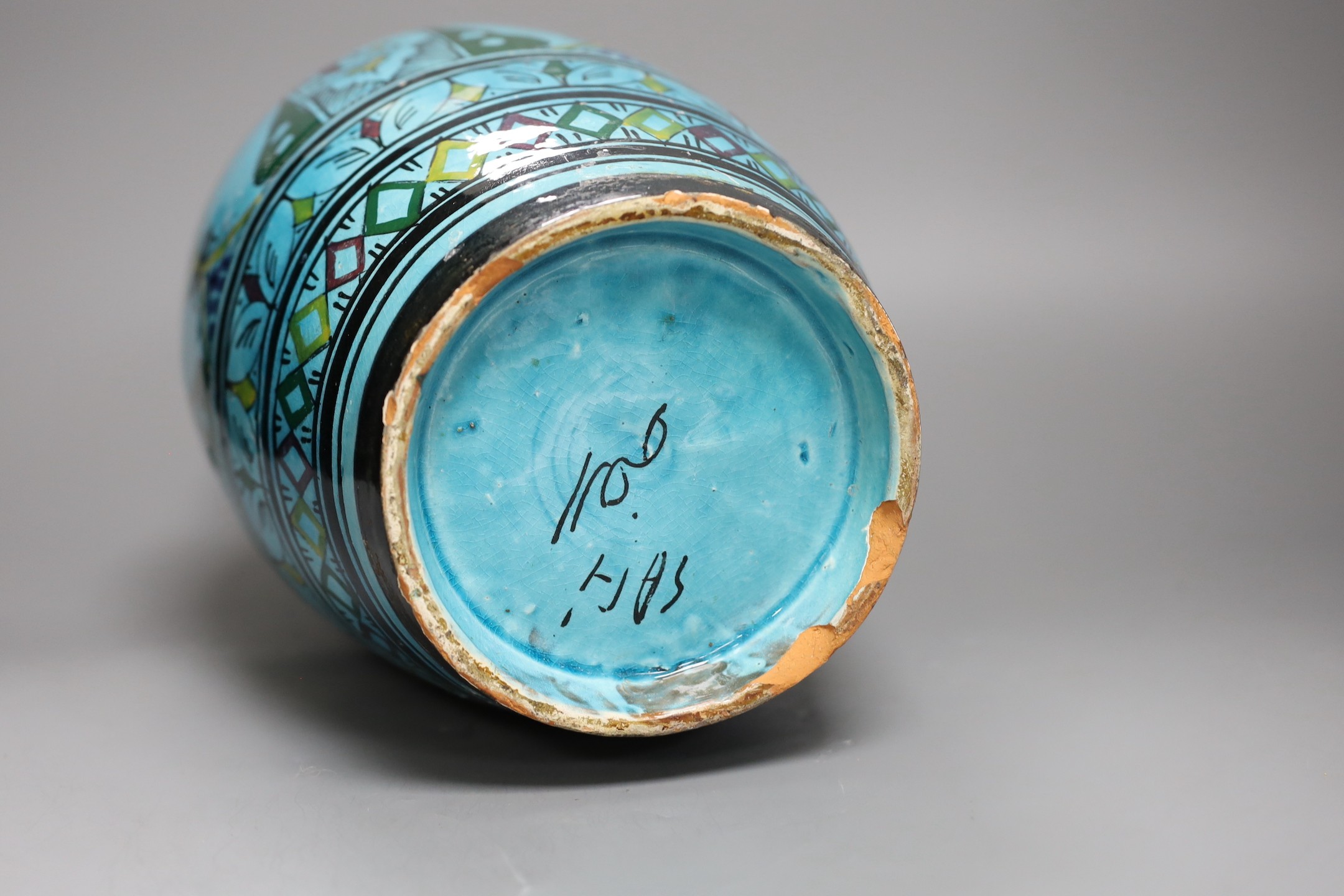 A large Persian ovoid painted terracotta vase, 34cm